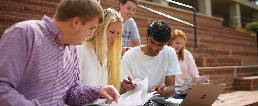 A group of students studying outside.